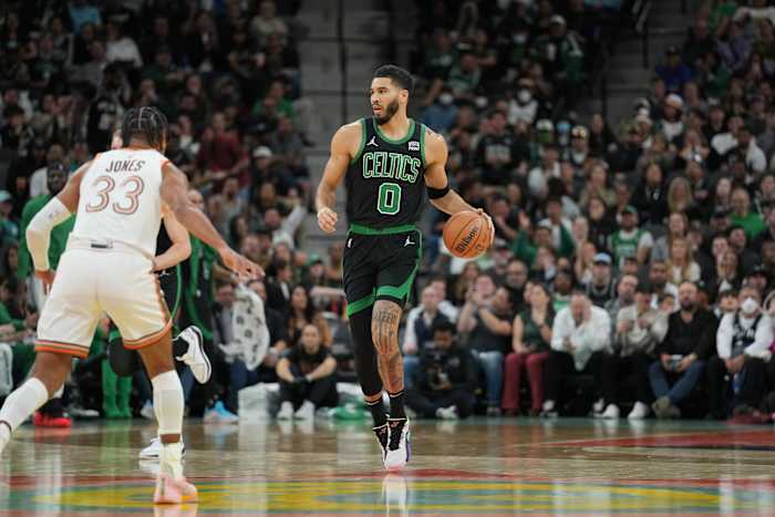 Dec 31, 2023; San Antonio, Texas, USA; Boston Celtics forward Jayson Tatum (0) dribbles the ball against San Antonio Spurs guard Tre Jones (33) in the first half at Frost Bank Center.
